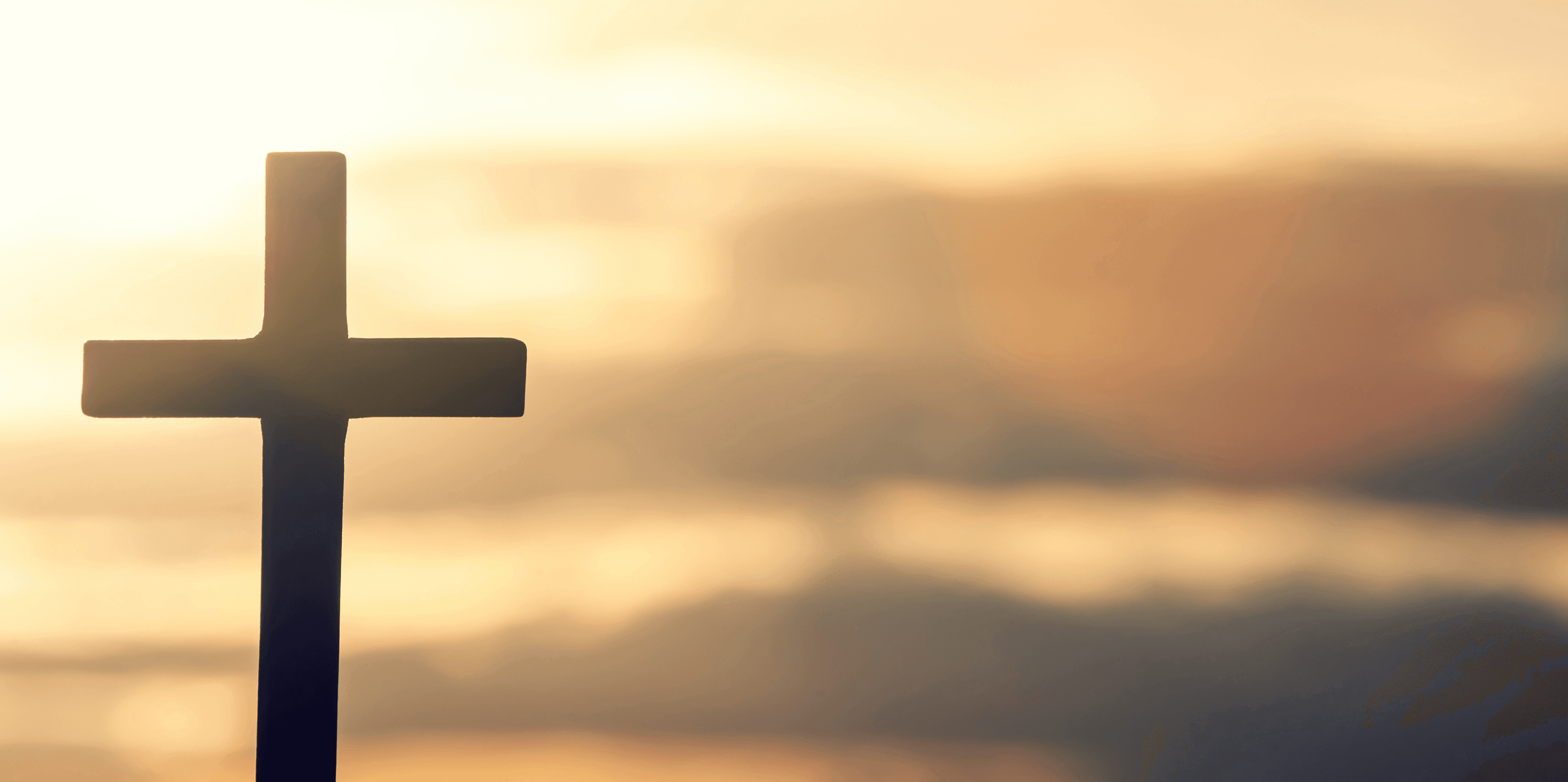 A cross silhouette stands prominently against a glowing sun